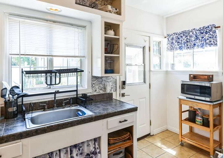 Enjoy seamless access to the backyard through the kitchen door for easy outdoor dining and relaxation. Enjoy seamless access to the backyard through the kitchen door for easy outdoor dining and relaxation.